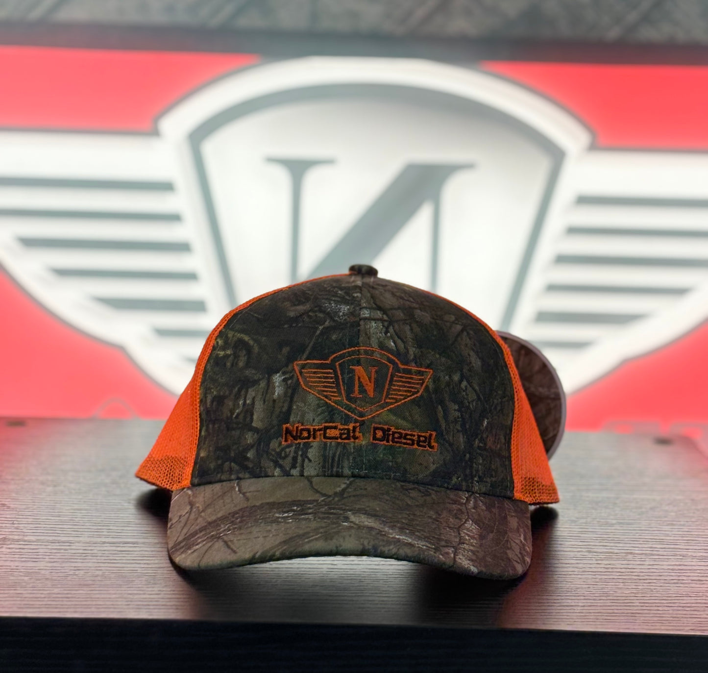 NORCAL DIESEL CAMO TRUCKER HAT W/ORANGE MESH